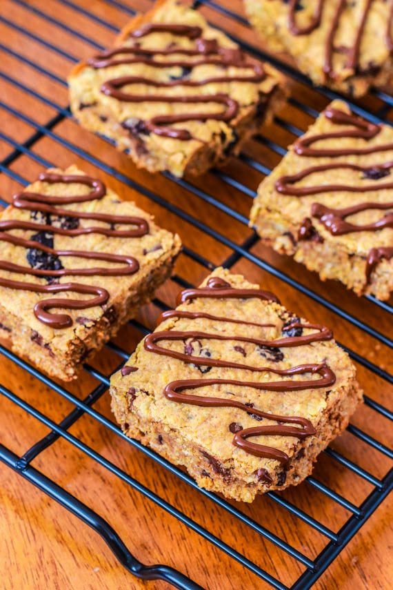peanut butter chunk oatmeal bars with a chocolate drizzle on a cooling rack