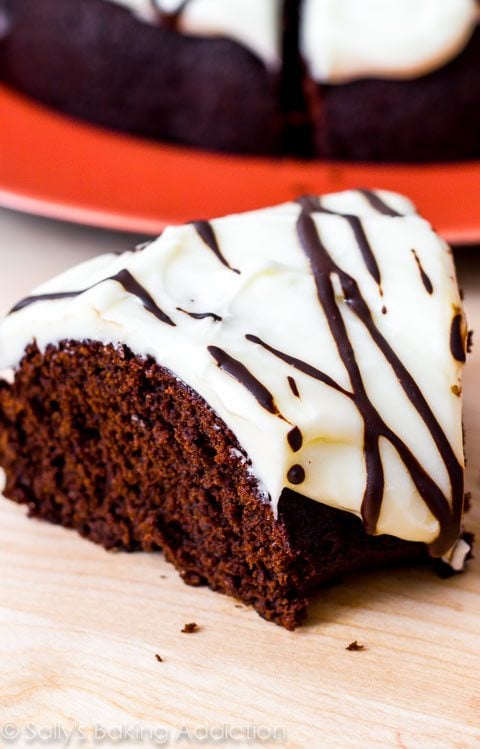 slice of chocolate gingerbread bundt cake with cream cheese frosting