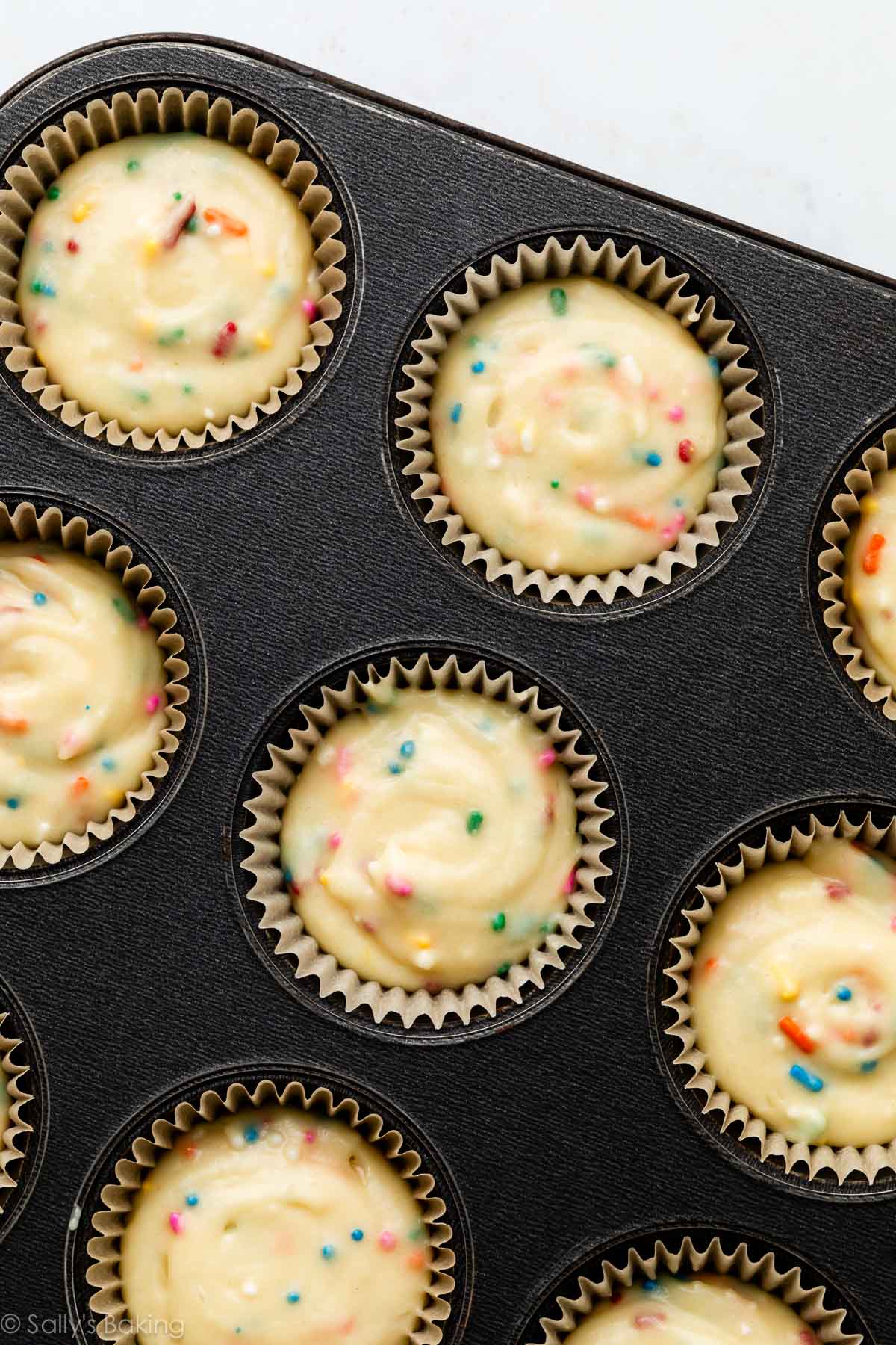 sprinkle cupcake batter in muffin pan.