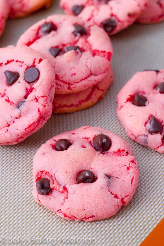 strawberry cookies with chocolate chips on a silpat baking mat