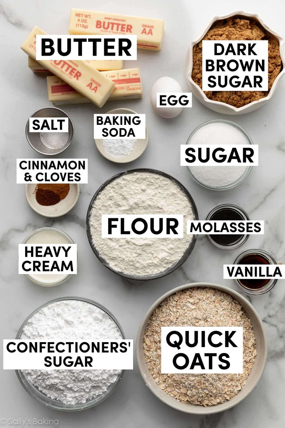 ingredients on marble surface including quick oats, confectioners' sugar, flour, molasses, dark brown sugar, butter, and an egg.