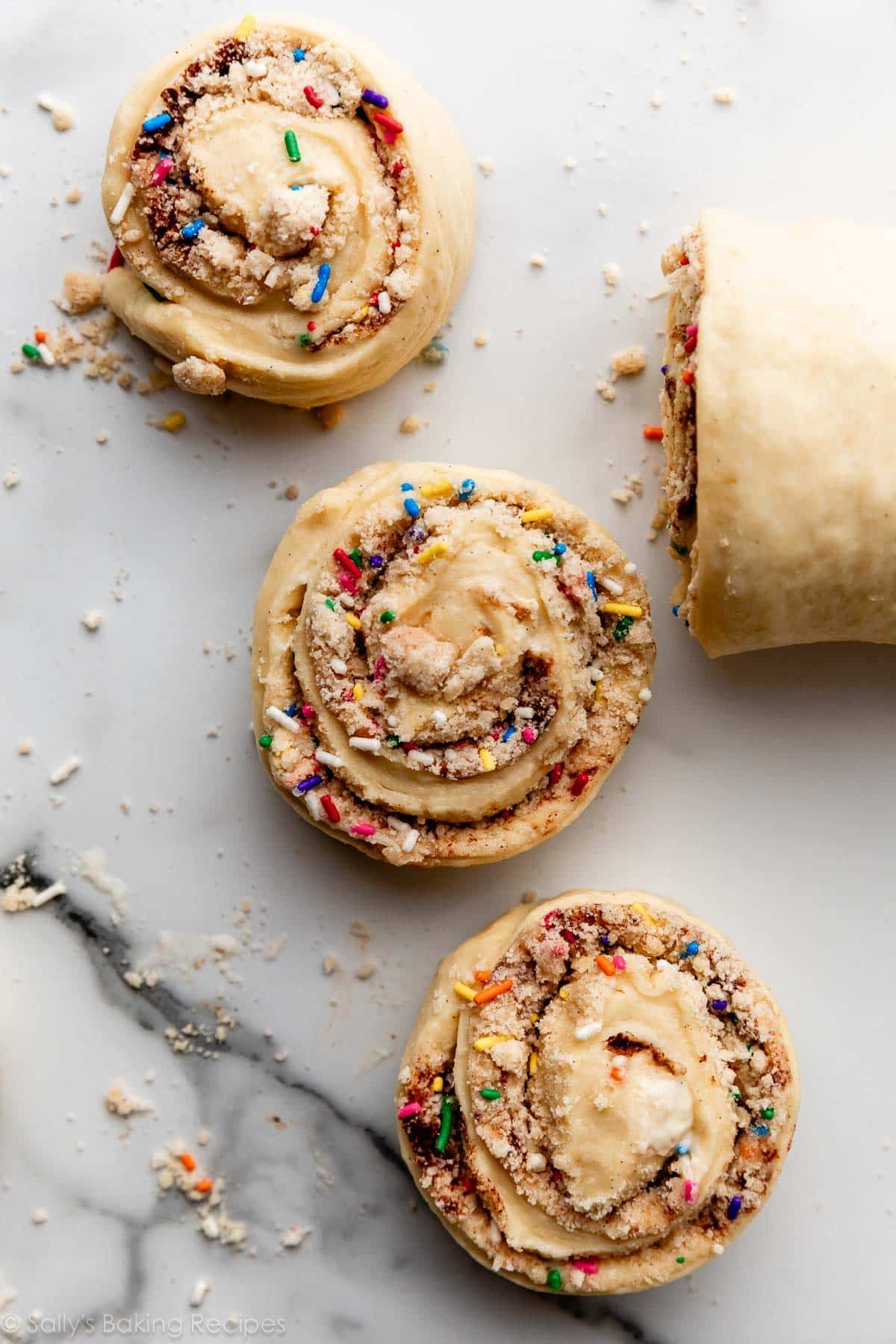 3 sprinkle cinnamon rolls cut before baking.