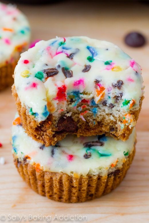 stack of 2 funfetti cheesecake cookie cups with a bite taken from one