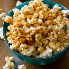 peanut butter caramel corn in a teal bowl