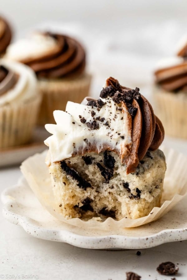 cookies and cream Oreo cupcake with swirled vanilla and chocolate frosting on top.