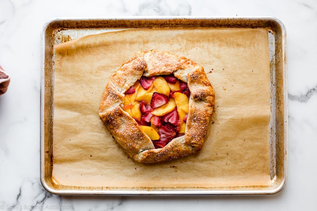 strawberry and peach tart on baking sheet