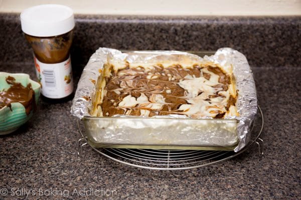 Nutella swirl cheesecake bars in a glass baking dish