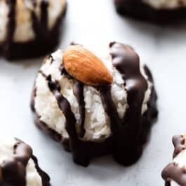 Coconut macaroons drizzled with dark chocolate and topped with an almond