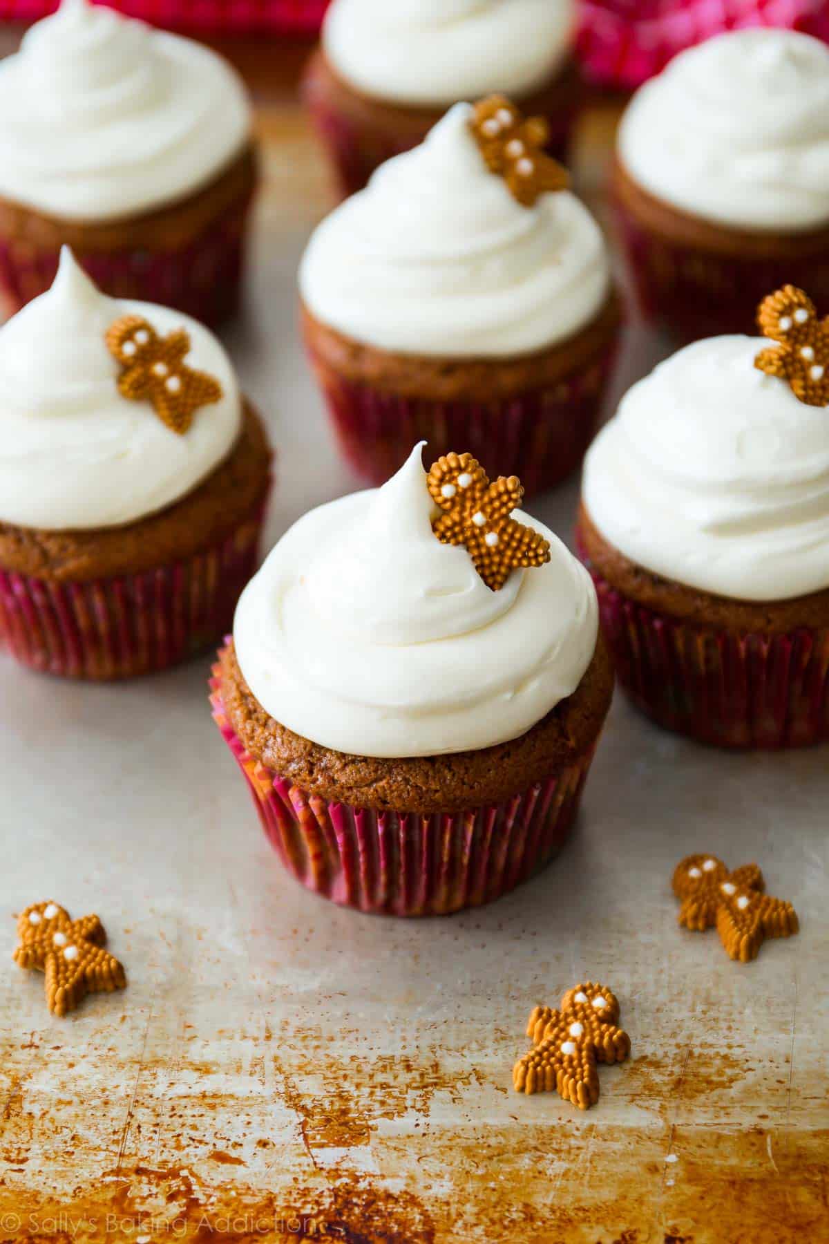 gingerbread cupcakes topped with cream cheese frosting and a decorative gingerbread man candy