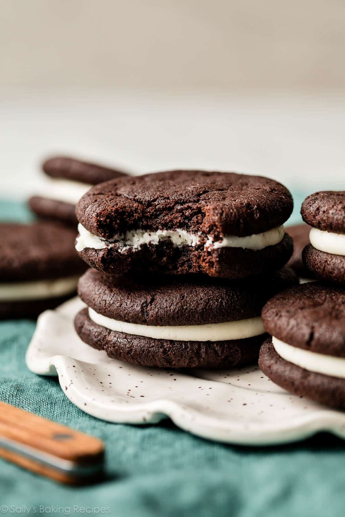 homemade Oreo cookie with a bite taken out on top of another one.