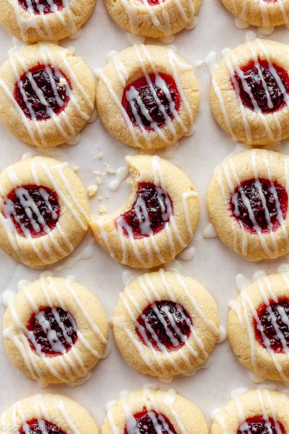 overhead photo of raspberry almond thumbprint cookies with icing.