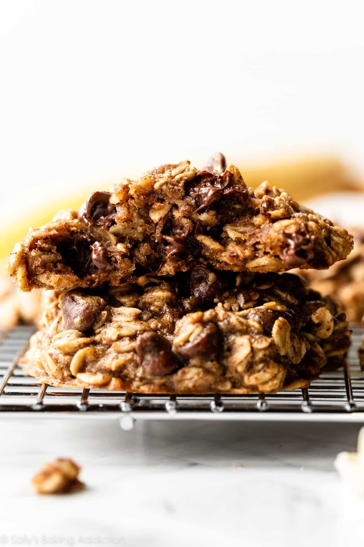 half of a banana oatmeal cookie stacked on top of a whole cookie.