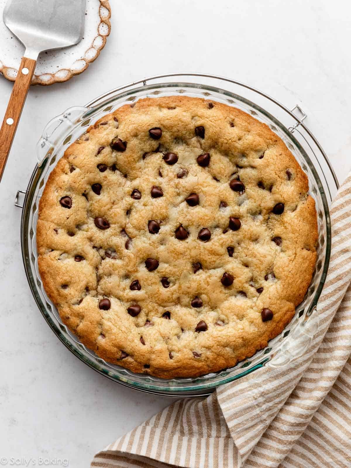 chocolate chip cookie cake baked in glass pie dish.