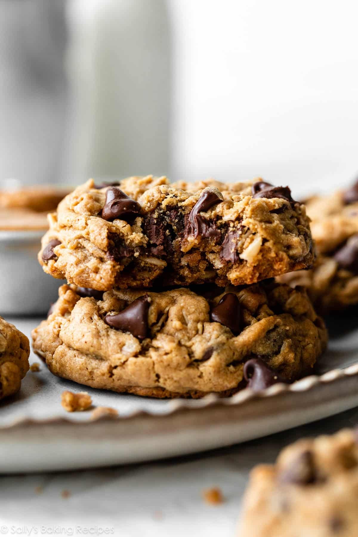 flourless peanut butter oatmeal cookie with a bite taken out on top of another cookie.