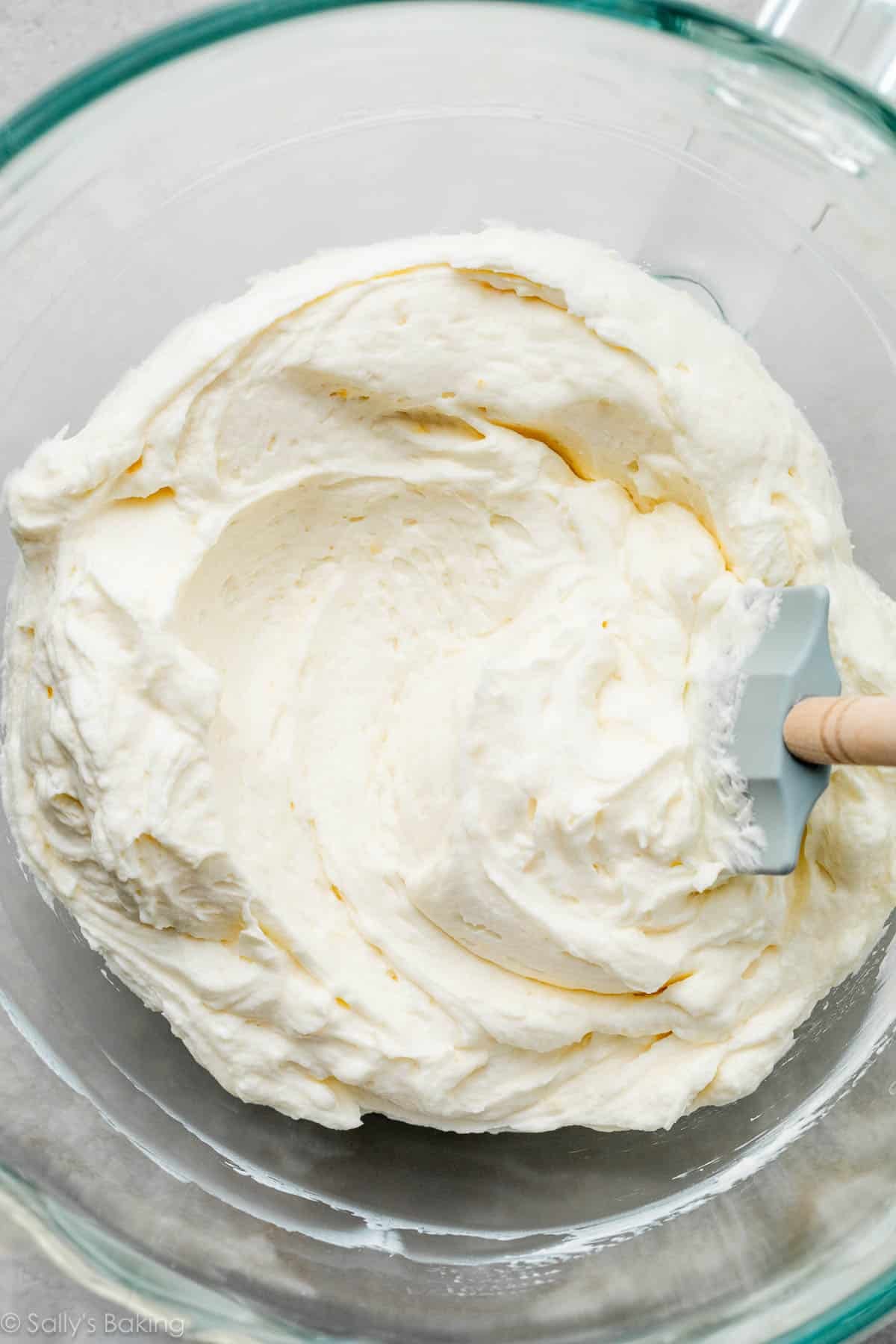 glass bowl of whipped cream cheese frosting.