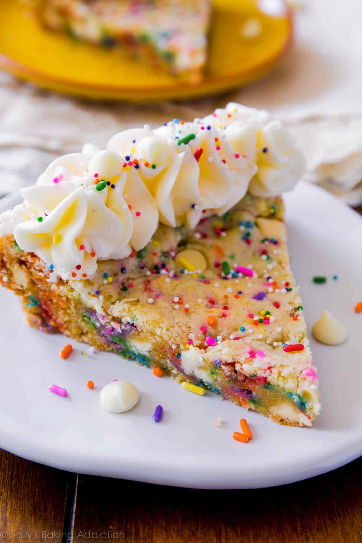 slice of funfetti sugar cookie cake on a white plate