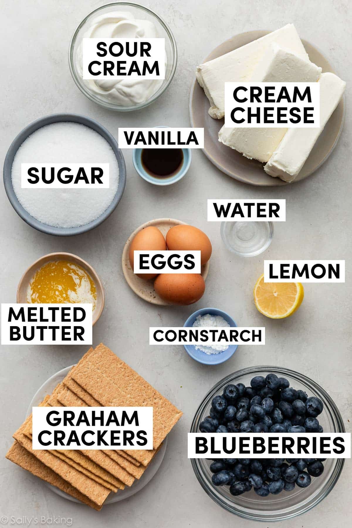 ingredients measured in bowls including melted butter, cream cheese, sour cream, sugar, and eggs.