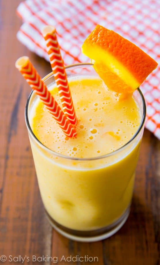 creamsicle smoothie in a glass with straws