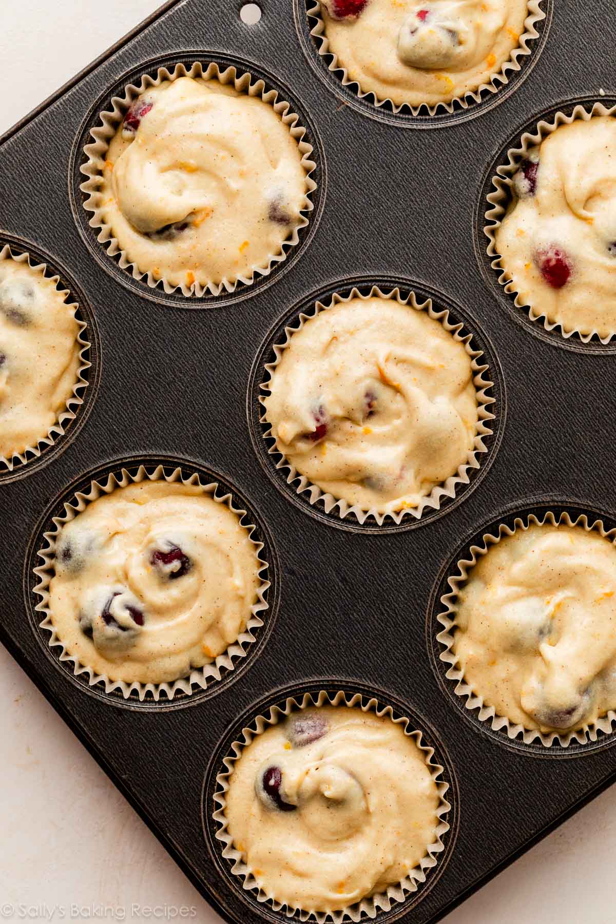 cranberry batter in lined muffin pan.