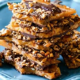 stack of salted dark chocolate almond toffee on a blue plate