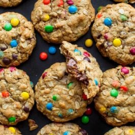 overhead image of monster cookies with one cookie broken in half showing a peanut butter cup inside