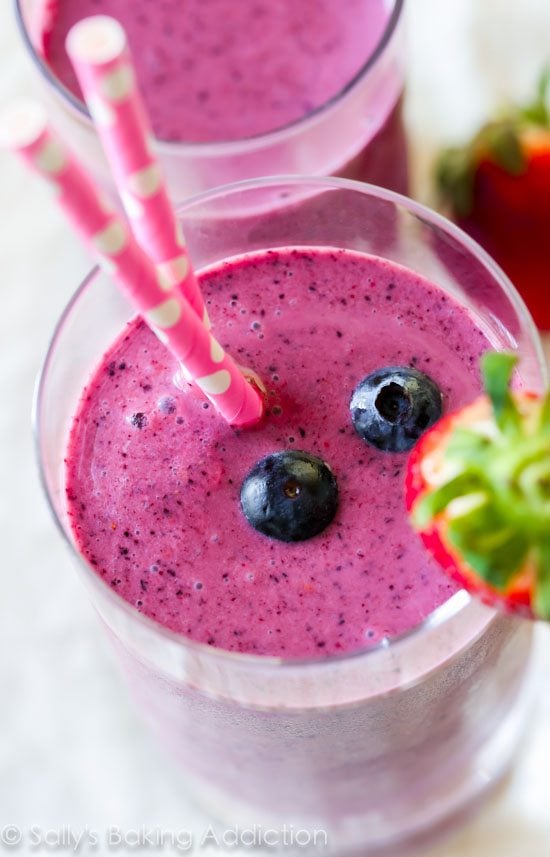 berry smoothies in glasses with straws