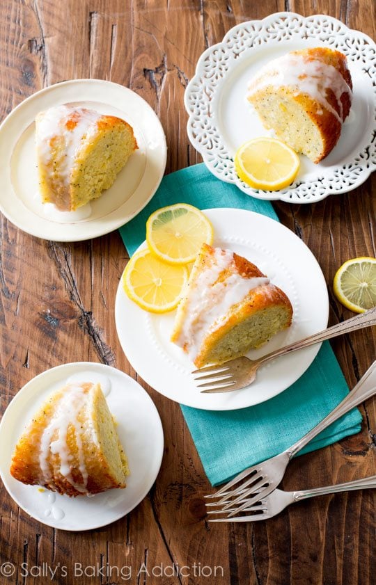 overhead image of slices of lemon poppy seed bundt cake on white plates with forks