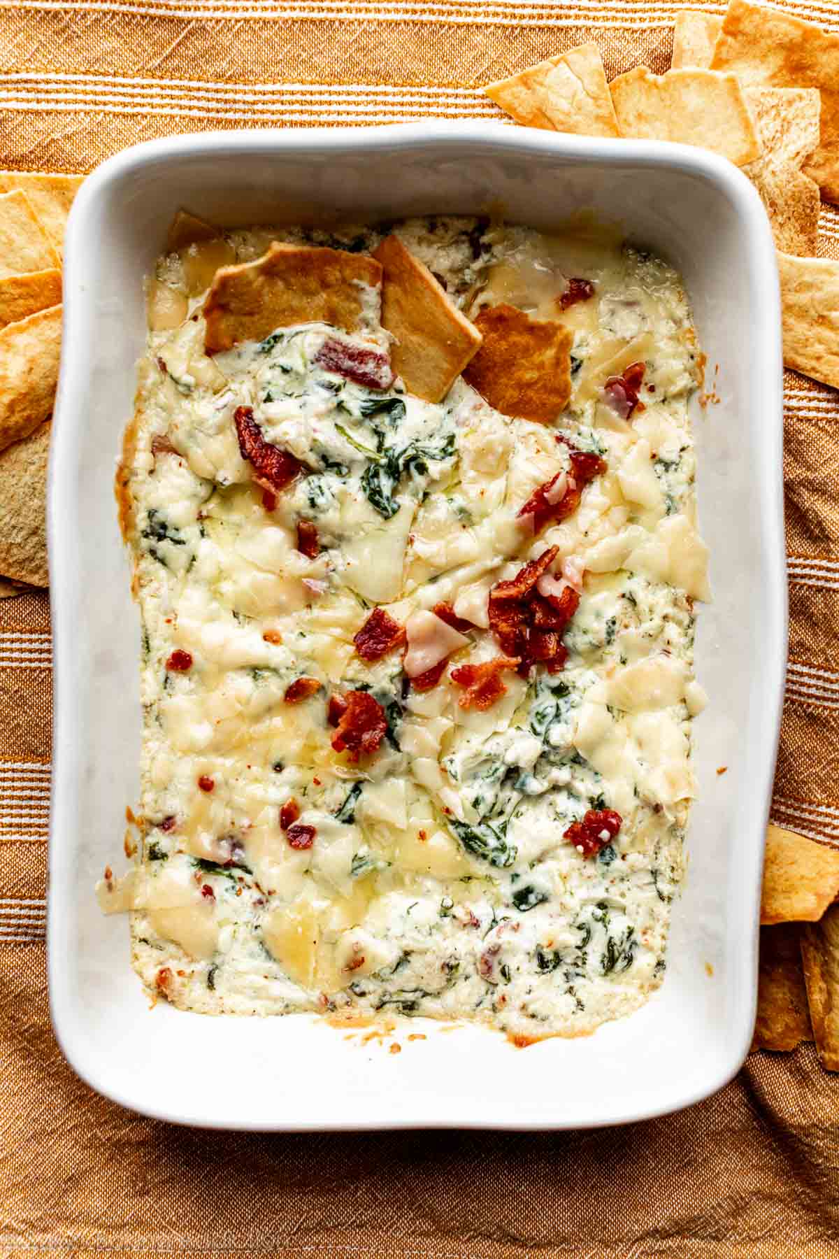 warm roasted garlic spinach dip in white baking pan