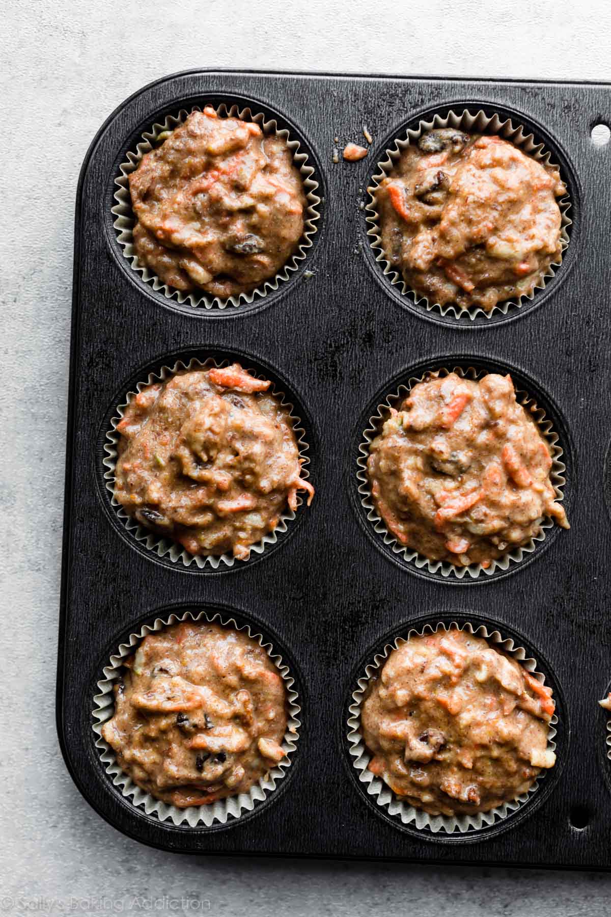 morning glory muffin batter in muffin pan