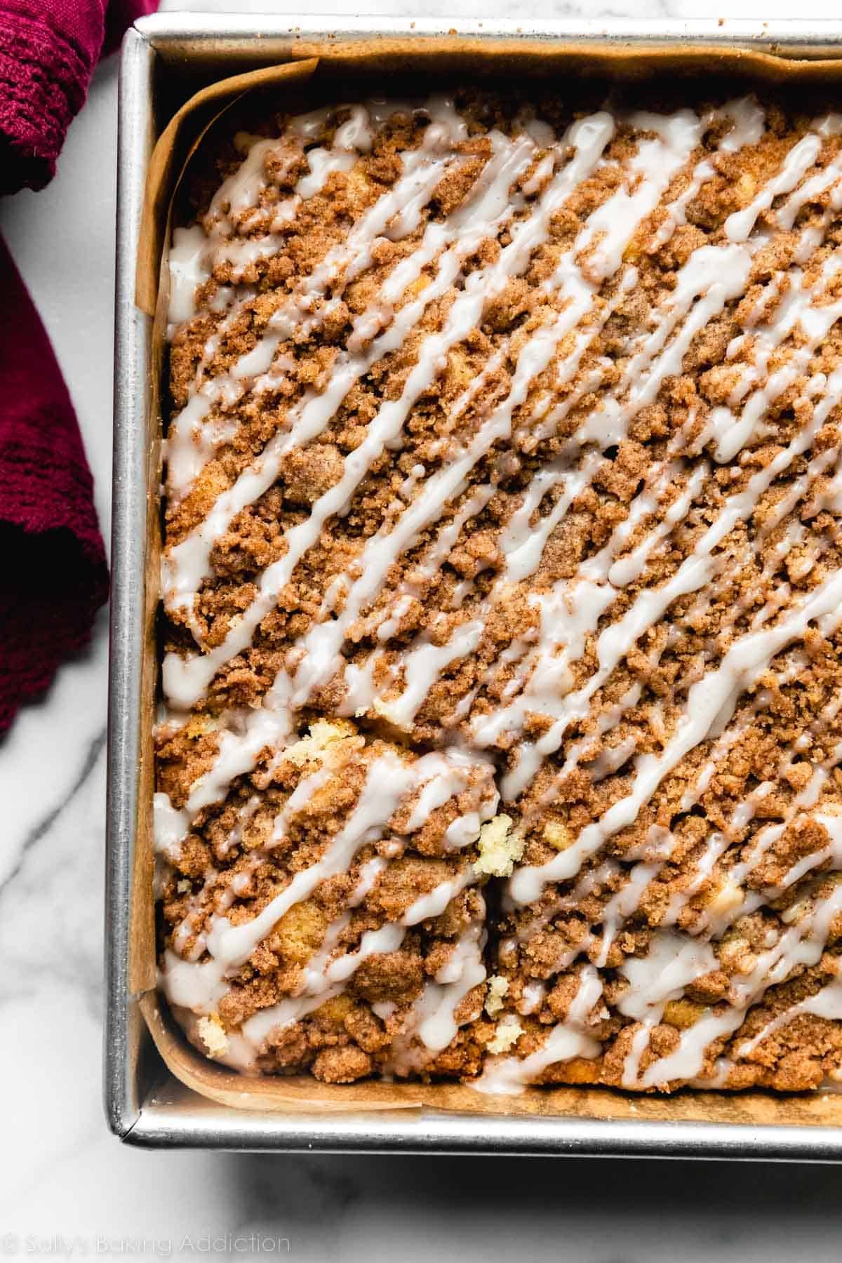 overhead photo of cinnamon crumb coffee cake in lined pan.