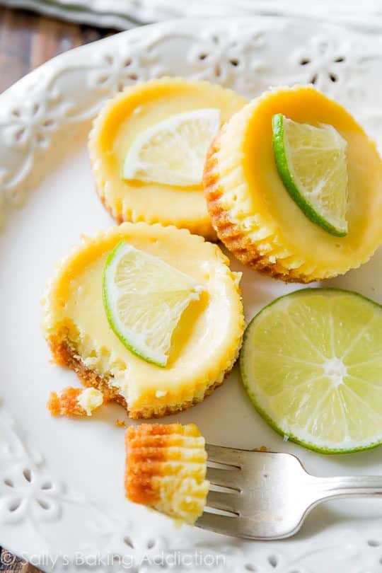 mini key lime pies on a white plate with a fork