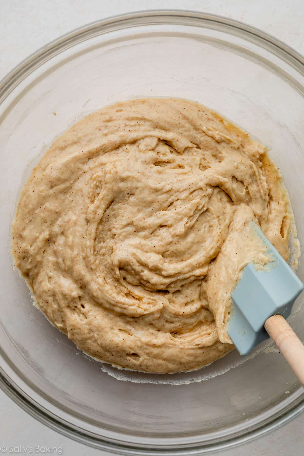 batter in glass bowl with blue spatula.
