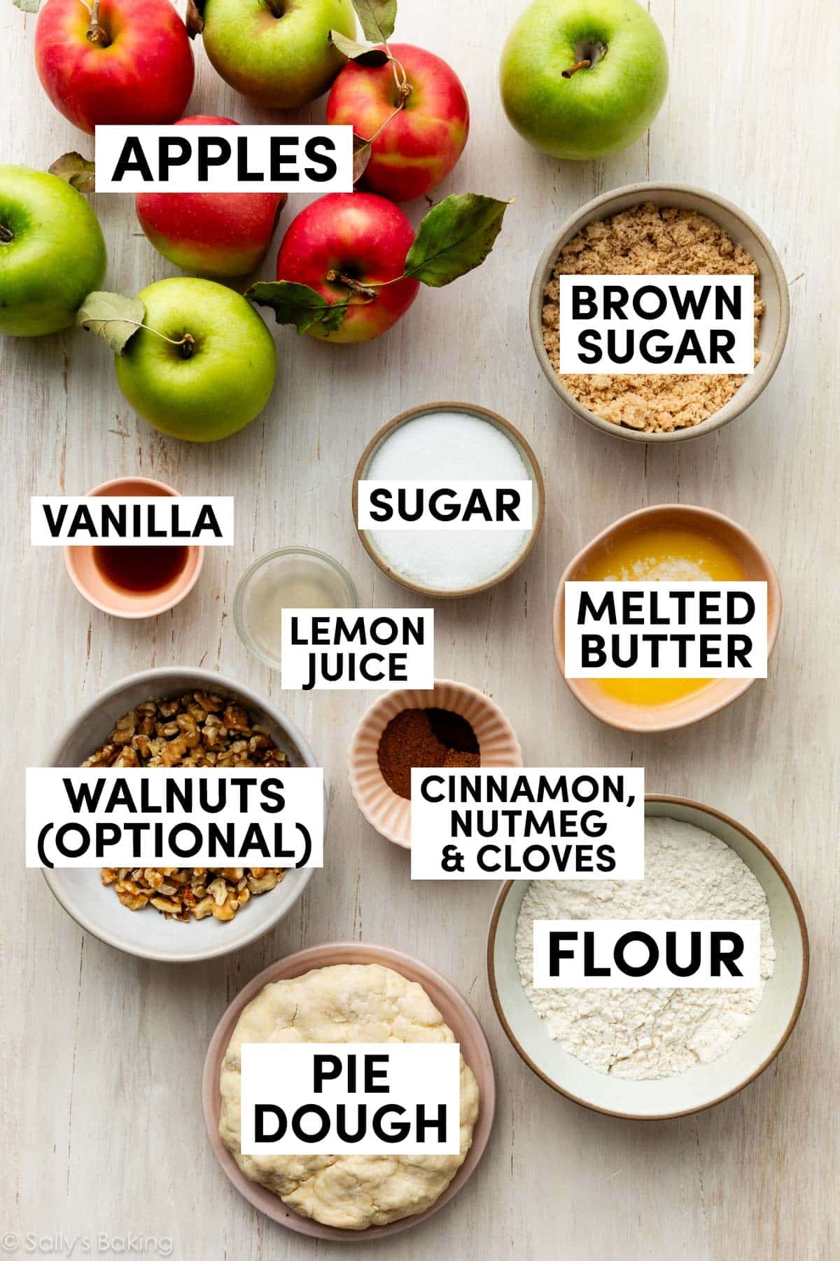 ingredients on surface including flour, melted butter, brown sugar, walnuts, vanilla, and spices.