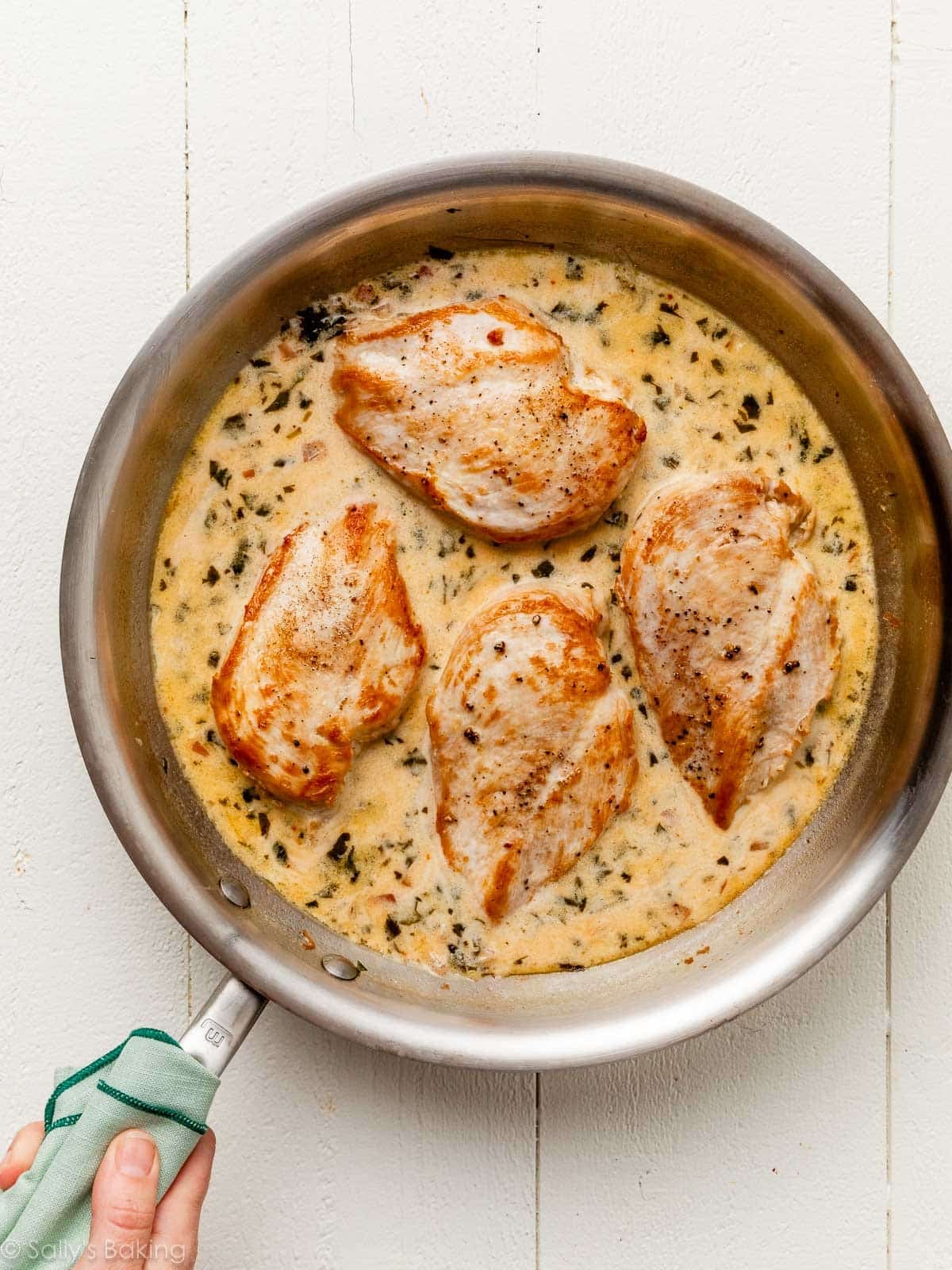 chicken in creamy sauce in skillet.