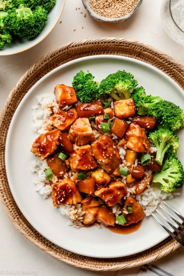 baked pineapple chicken teriyaki on white plate with broccoli and white rice.