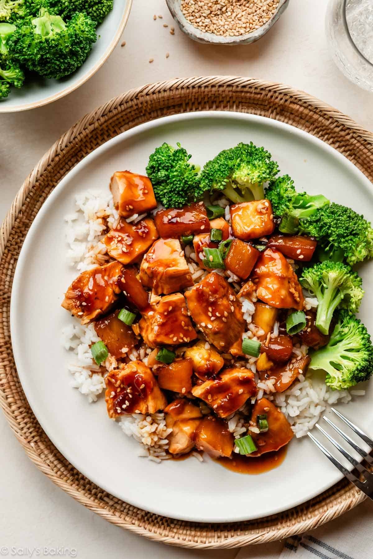 baked pineapple chicken teriyaki on white plate with broccoli and white rice.