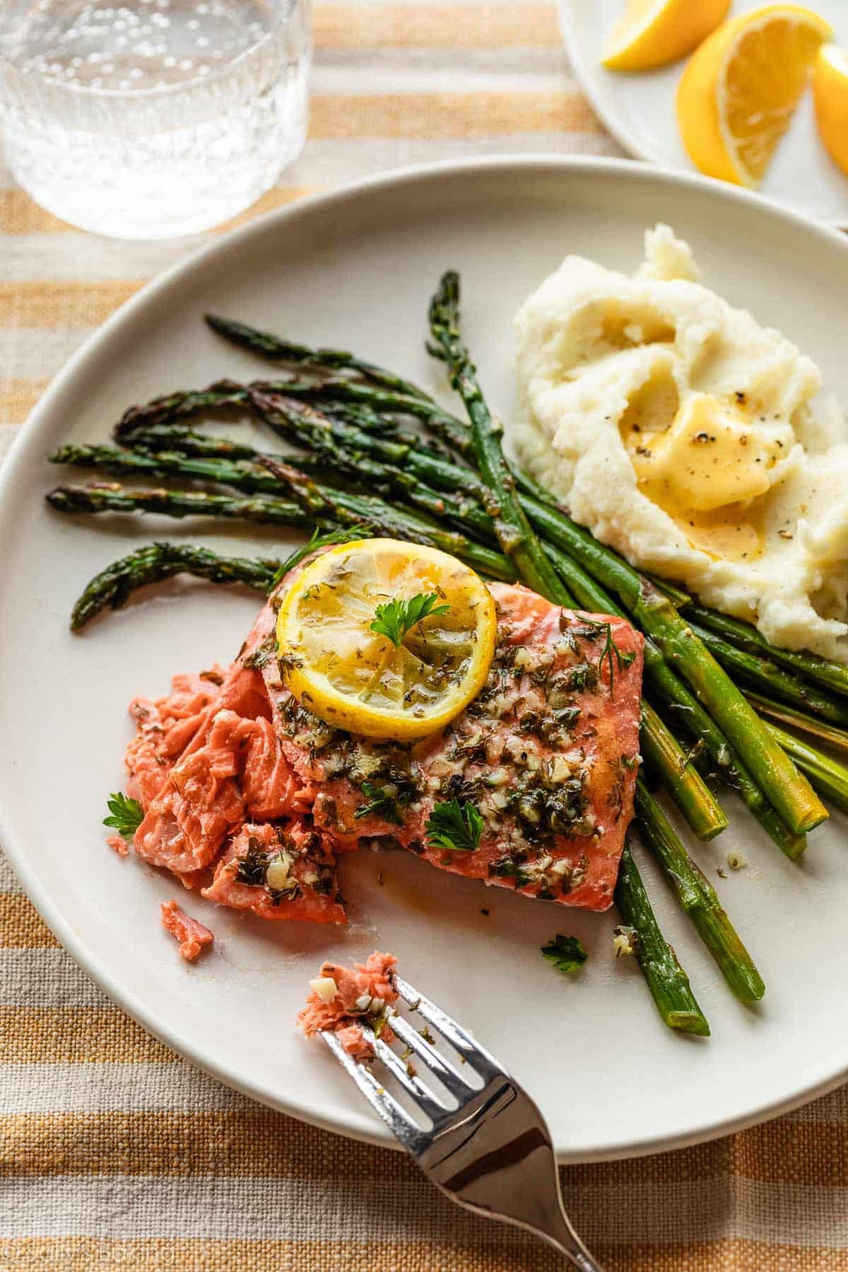 lemon garlic salmon on plate with asparagus and mashed potatoes.