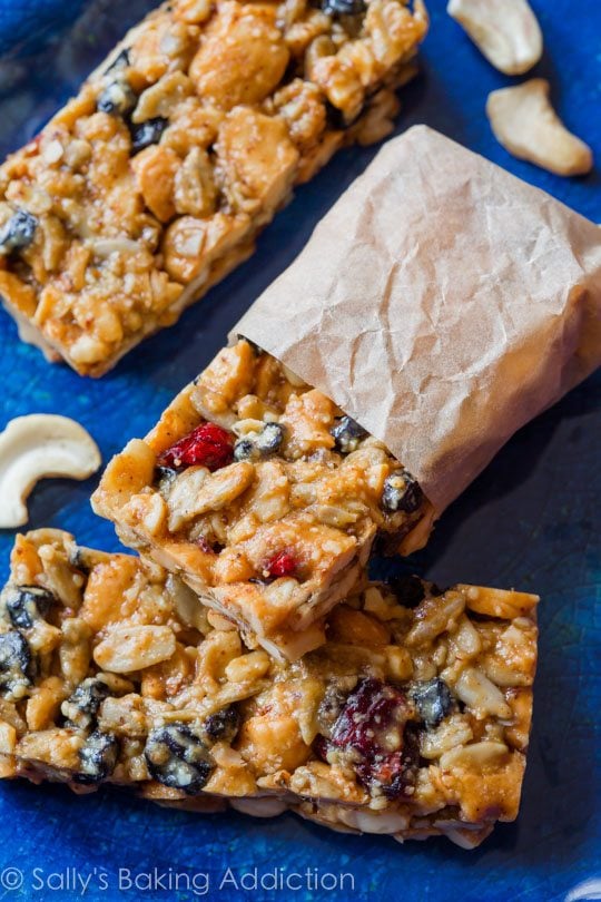 Berry vanilla cashew snack bars with one wrapped in parchment paper