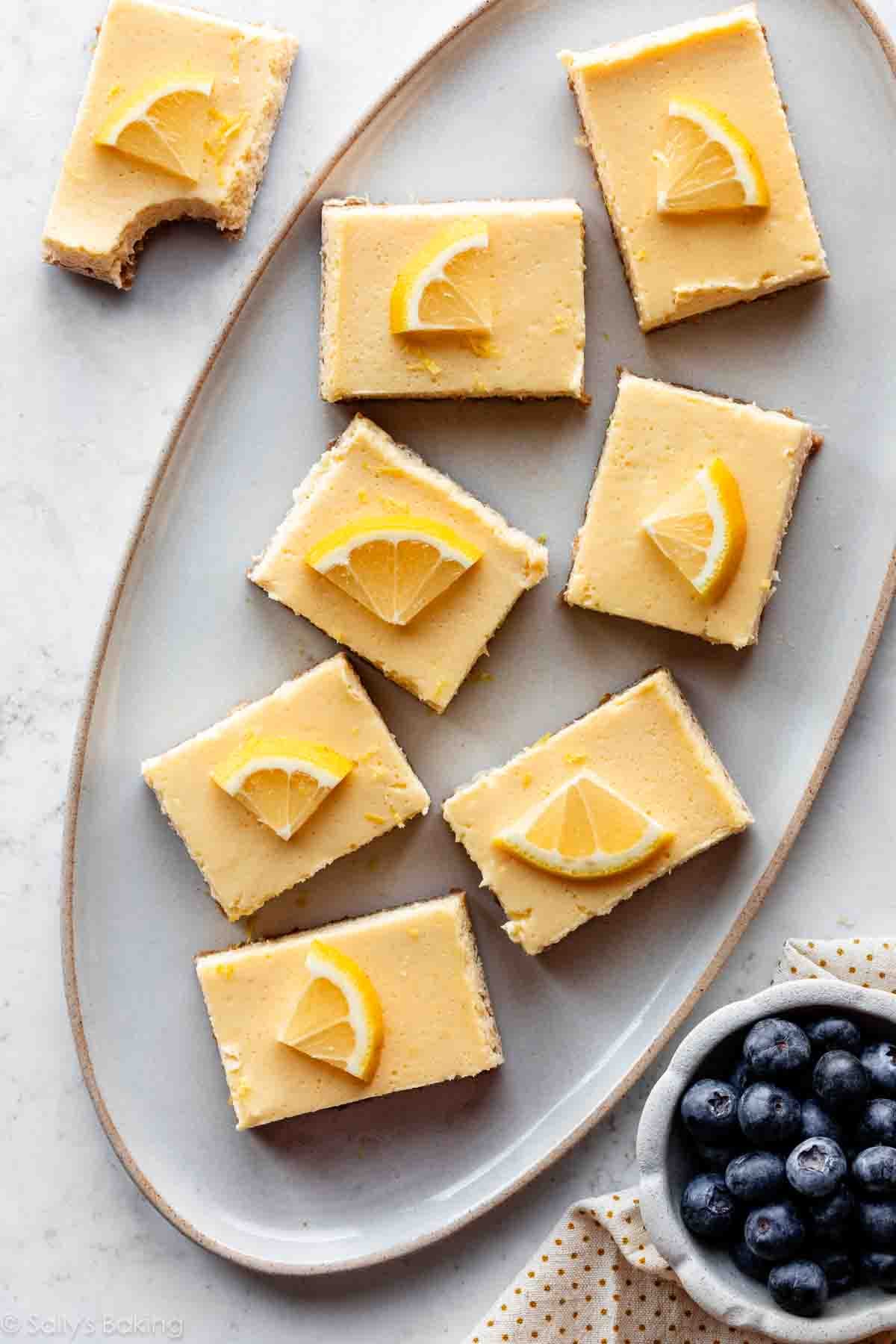 creamy yogurt lemon bars on oval serving platter.