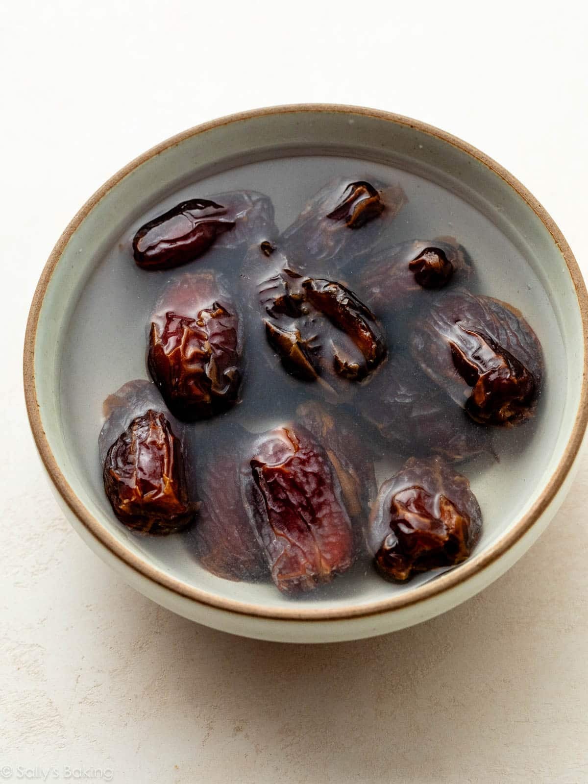 dates soaking in water in bowl.