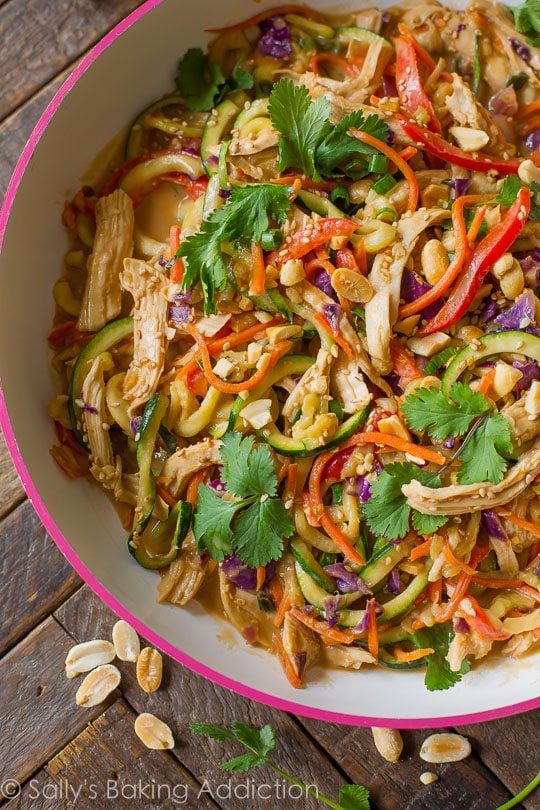 peanut chicken zucchini noodles in a pink skillet