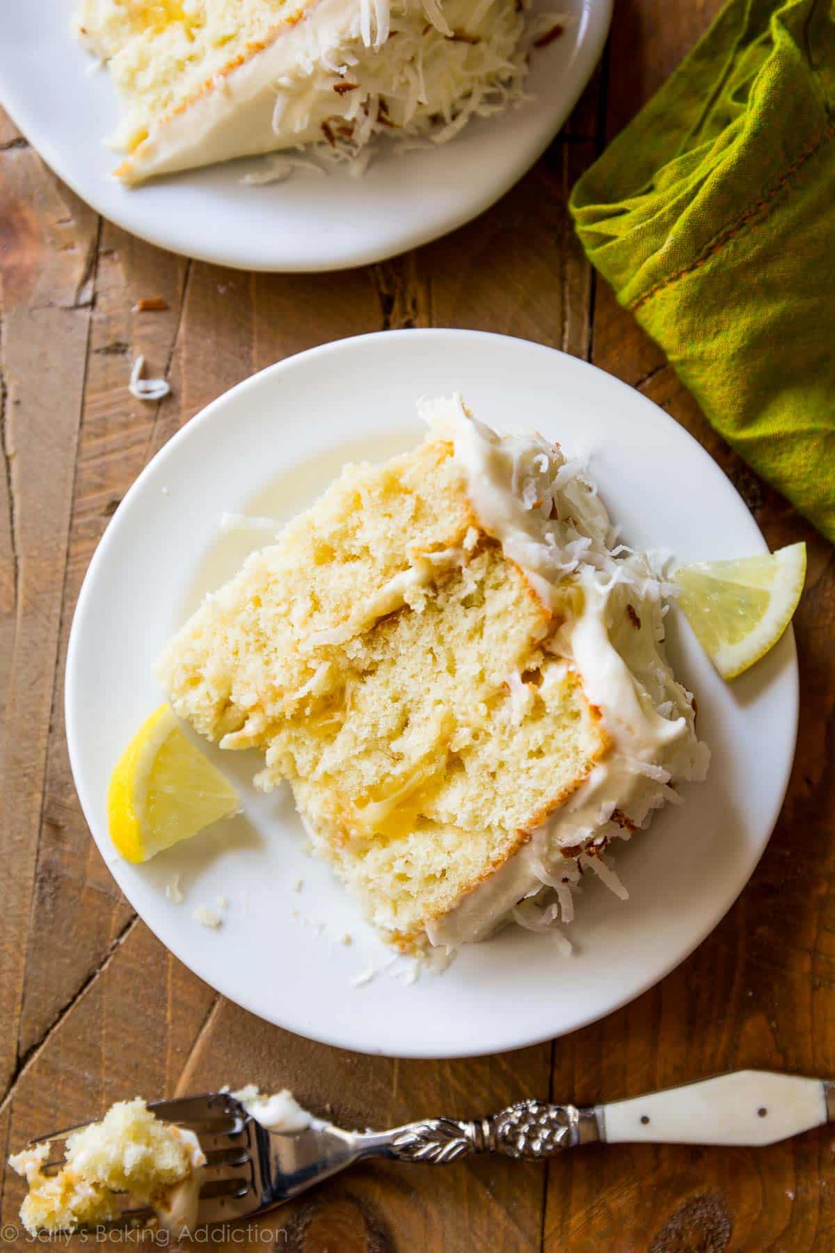 slices of lemon coconut cake on a white plates with a fork