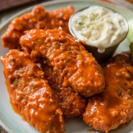 buffalo chicken fingers on a blue plate
