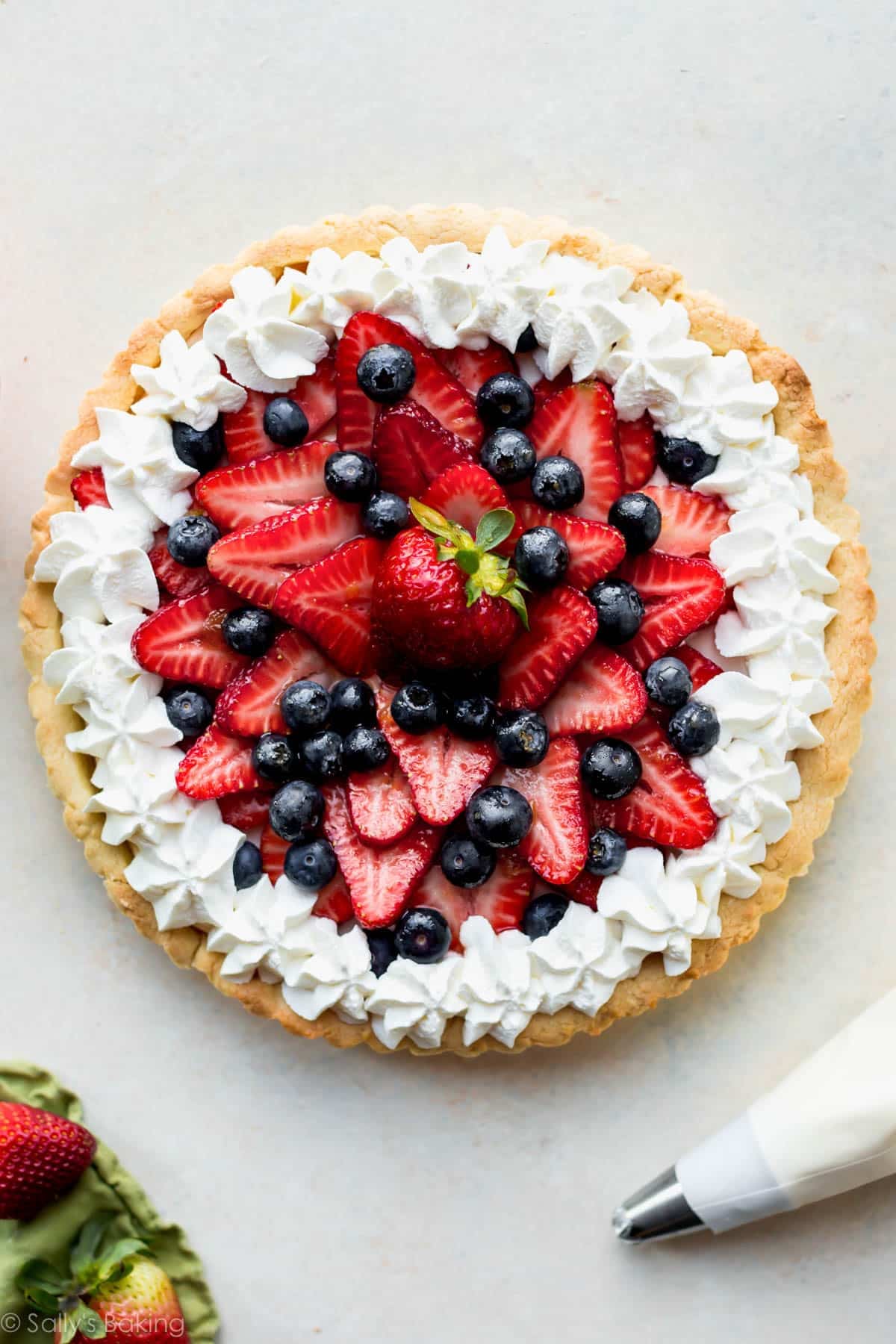 fresh berry fruit tart with whipped cream.