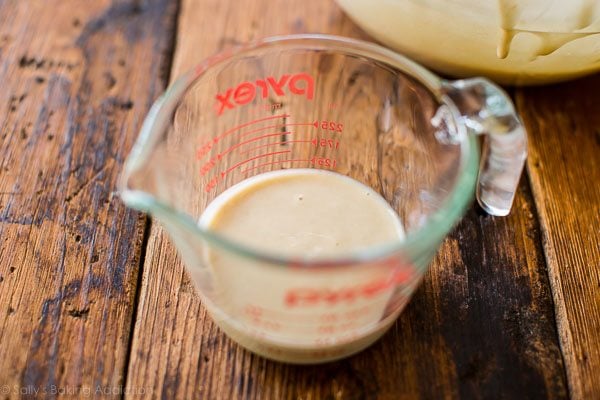 funnel cake batter in a glass measuring cup