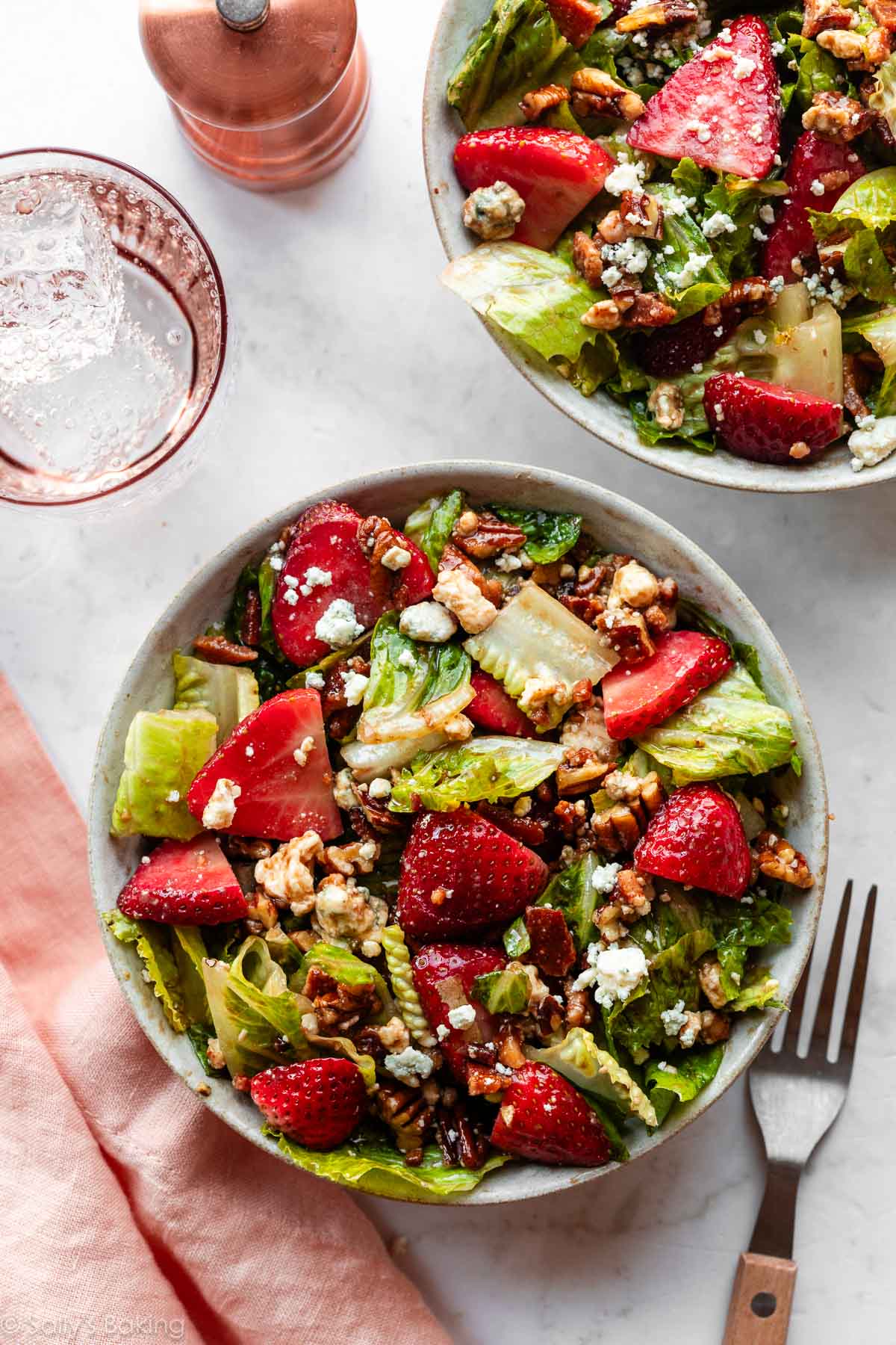 bowls of strawberry bacon salad with blue cheese.