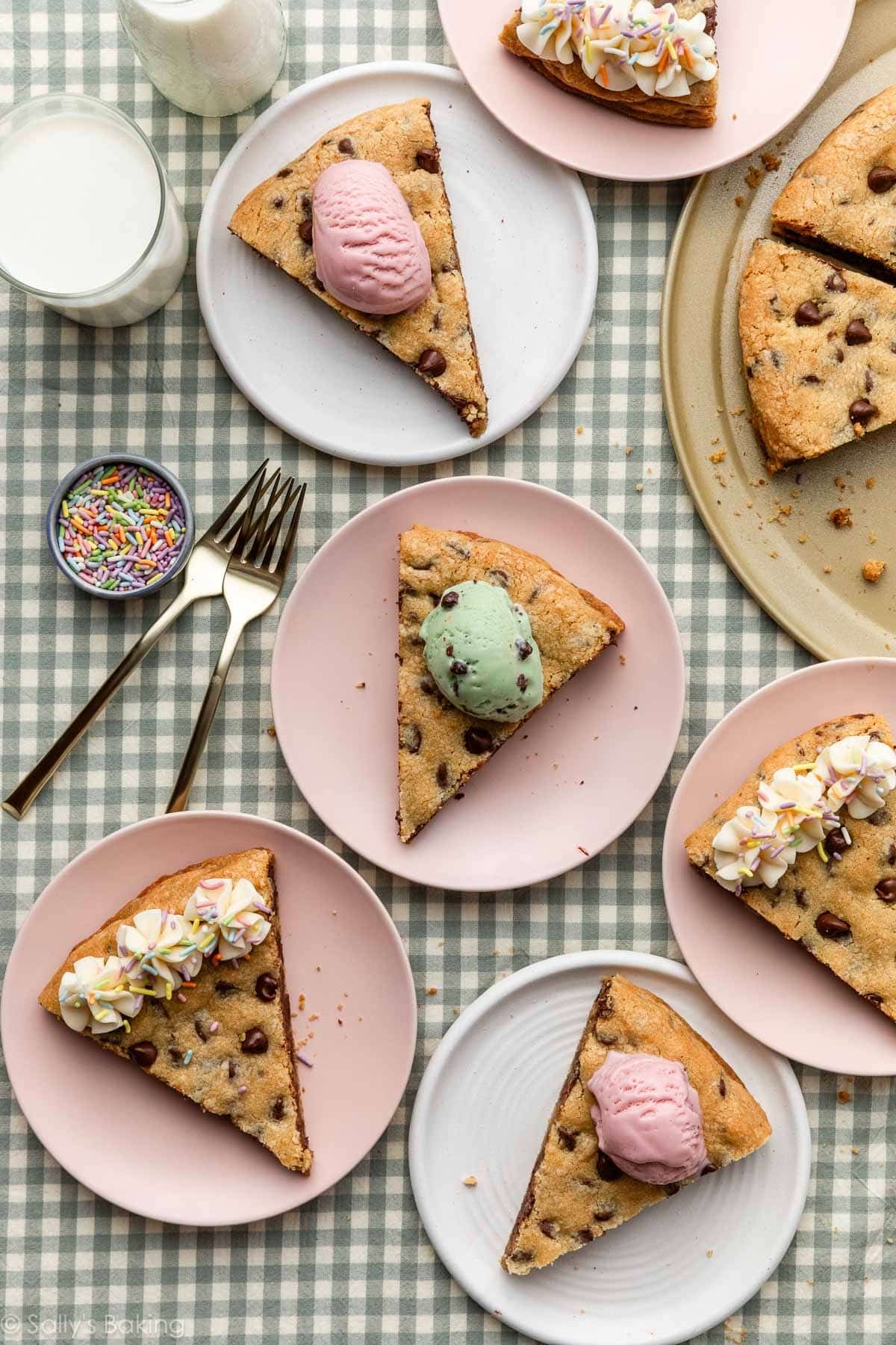 slices of cookie pizza on plates with ice cream on top.