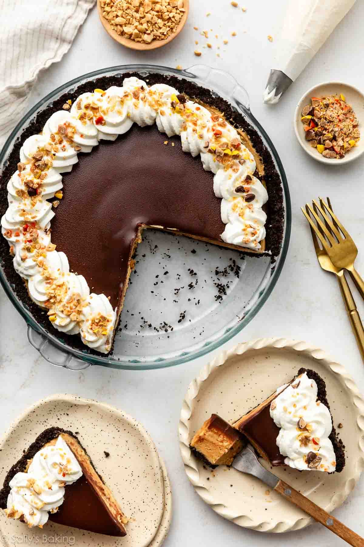 overhead photo of peanut butter pie with chocolate ganache, whipped cream, and Reese's Pieces.