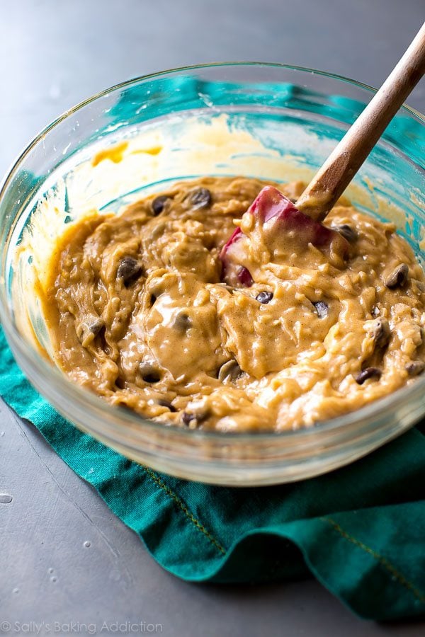 dark chocolate coconut blondie batter in a glass bowl with a spatula