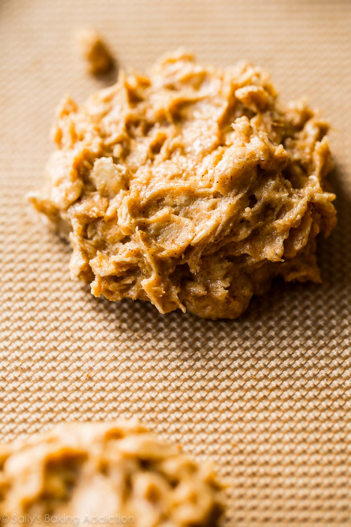 brown butter pumpkin oatmeal cookie dough mounds on a silpat baking mat